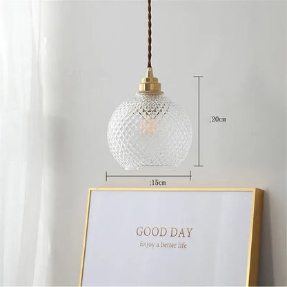 Clear glass ball led pendant light with diamond-cut pattern brass hardware and twisted brown cord for dining room decorbites