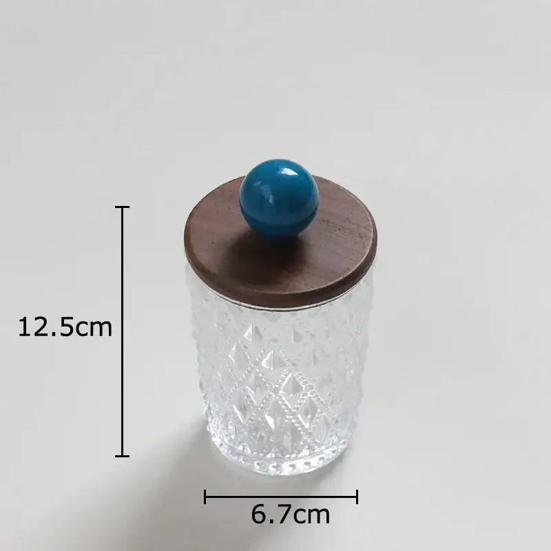 Clear glass jewelry jar with textured diamond pattern, walnut lid, and decorbites colorful ceramic teal ball knob