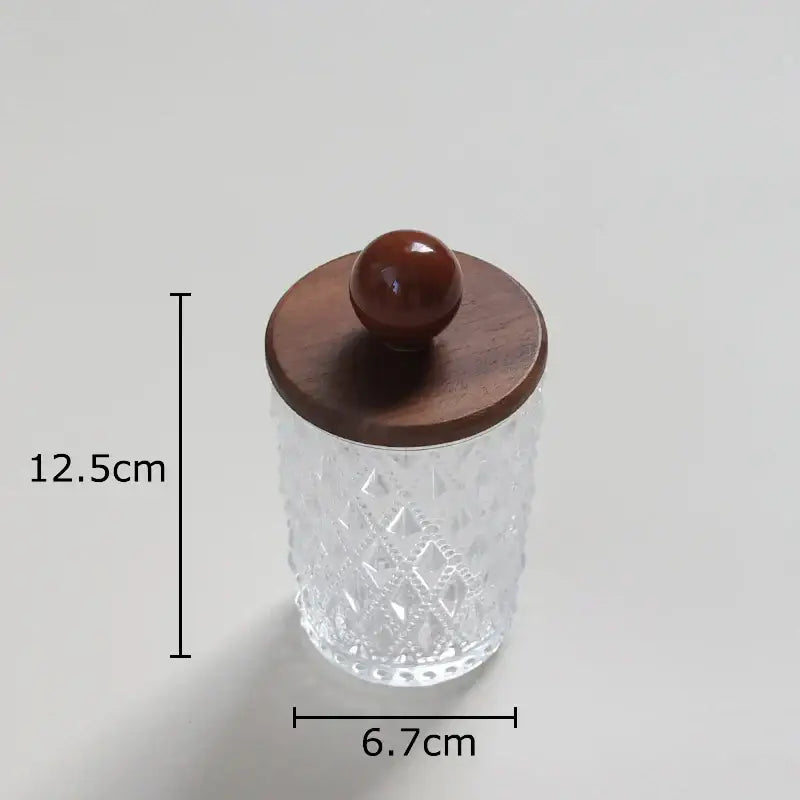 Clear glass jewelry jar with diamond pattern and walnut lid featuring a polished round knob for bedroom storage
