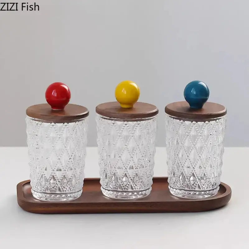 Set of three clear glass jewelry jars with diamond pattern and walnut lid featuring decorbites colorful ceramic ball tops