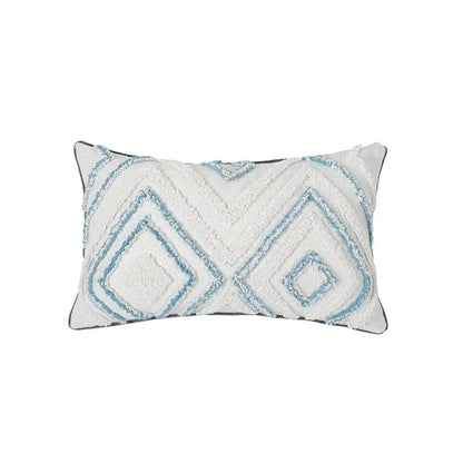 A rectangular white cushion cover with diamond tufted blue geometric patterns and a dark gray border for living room use