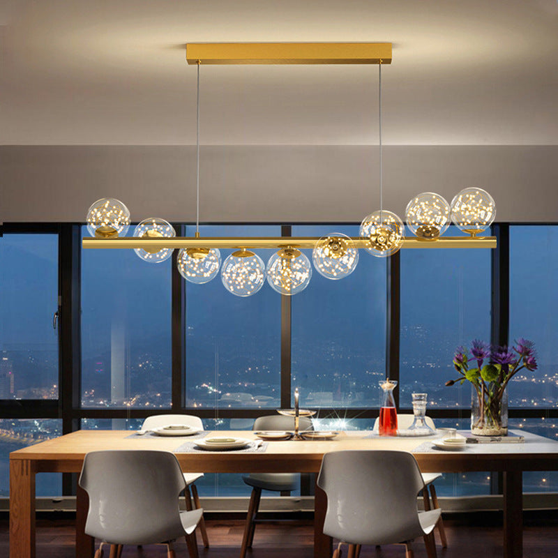 Gold rectangular dining room chandelier with glass globe accents featuring a creative 3d long light source design