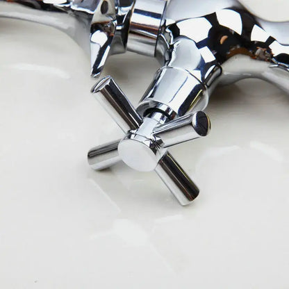 Chrome finished decorbites dolphin shape bathroom faucet with dual cross handles and a sleek reflective metallic finish