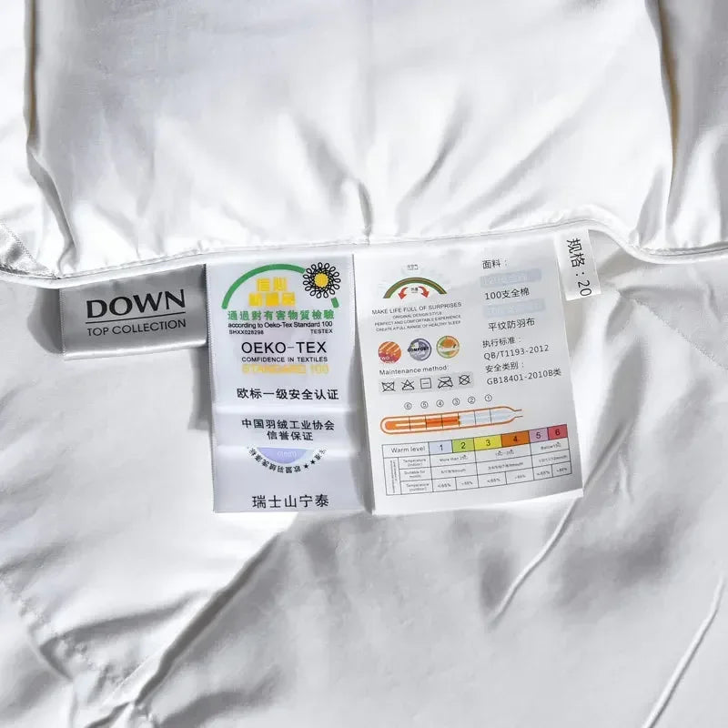 White down duvet with silver black labels showing down top collection branding oeko-tex certification and care instructions