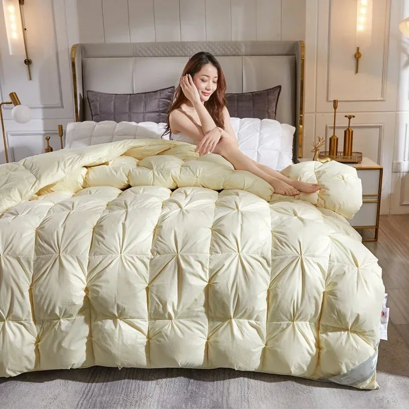 Cream-colored quilted down duvet with plush starburst pattern filled with 95 white goose down for warm comfort