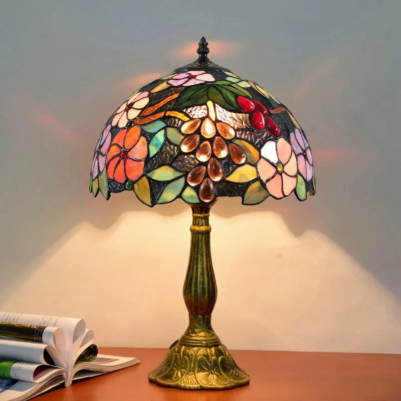 Dragonfly tiffany stained glass table lamp with floral grapevine design and multicolored panels on brass base
