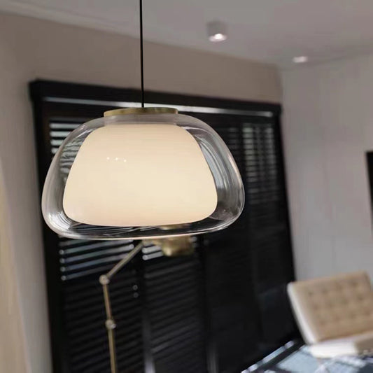 Modern pendant light hanging in a room with a blurred background