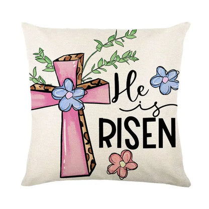 Beige linen cushion cover featuring a pink cross with leopard print accents blue and pink flowers and he is risen text for easter bunny rabbit decor