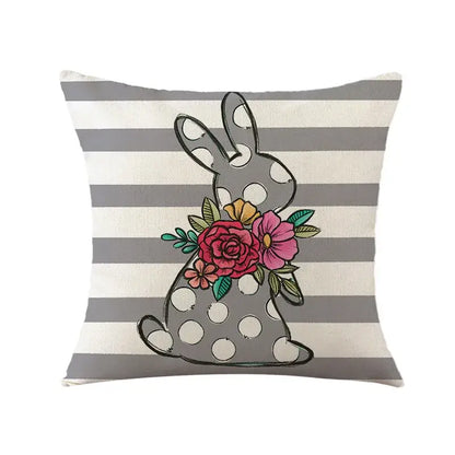 Gray polka-dotted easter bunny rabbit linen cushion cover with colorful floral design on a striped living room pillow