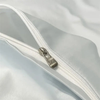 Silver-toned zipper pull on white satin-like fabric of decorbites 1000tc egyptian cotton duvet cover set