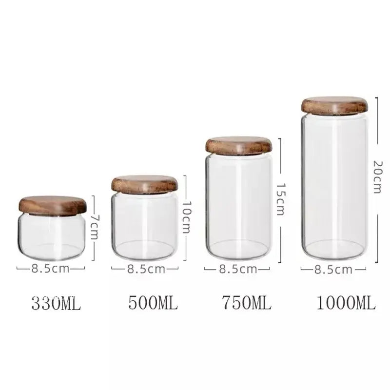 Set of four clear glass storage jars with elegant acacia wood lids in 330ml to 1000ml kitchen capacities