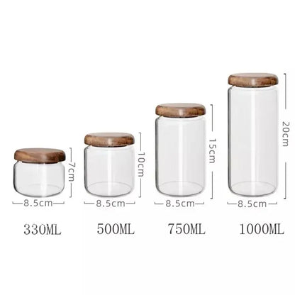 Set of four clear glass storage jars with elegant acacia wood lids in 330ml to 1000ml kitchen capacities