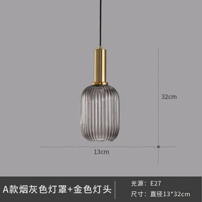 Elegant smoked gray glass pendant light with vertical ridges and gold-toned metal fixture for dining room pendant lights