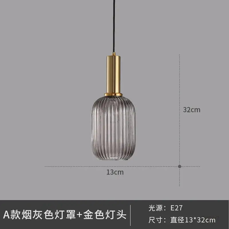 Elegant smoked gray glass pendant light with vertical ridges and gold-toned metal fixture for dining room pendant lights