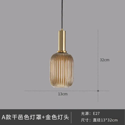 Elegant amber ribbed glass pendant light with vertical ridges and gold-toned metal fixture for dining room pendant lights