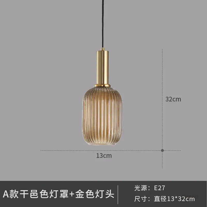 Elegant amber ribbed glass pendant light with vertical ridges and gold-toned metal fixture for dining room pendant lights