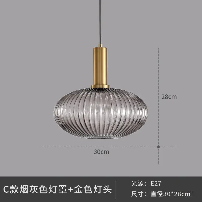 Elegant glass pendant lights with smoked gray ribbed glass and polished gold metal fixture for dining room lighting