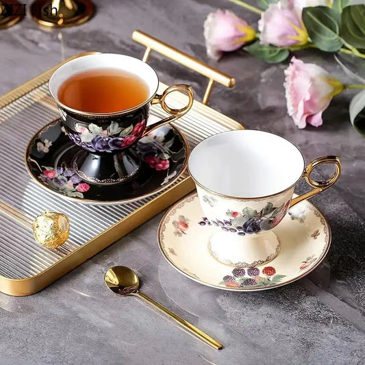 Elegant black and cream fruits pattern ceramic tea set with gold-trimmed floral cups and saucers by decorbites fruits pattern
