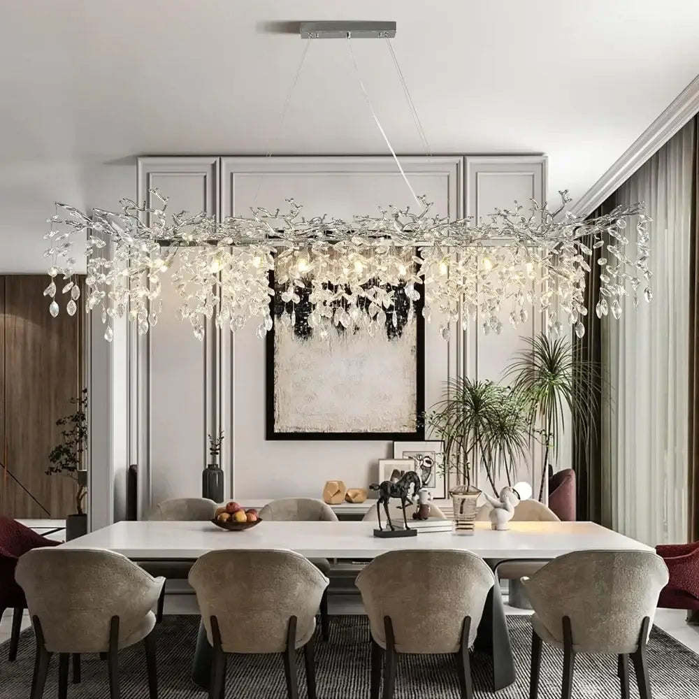 A modern silver-toned pendant light with intricate branch design and crystal droplets decorbites crystal suspension