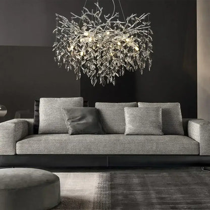 A modern silver-toned pendant light with intricate metallic frame and dangling crystal leaves for dining room decorbites crystal suspension