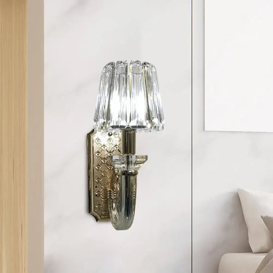 Elegant brass and crystal tapered cone sconce light with crystal-encrusted curved arm and polished brass backplate for bedroom