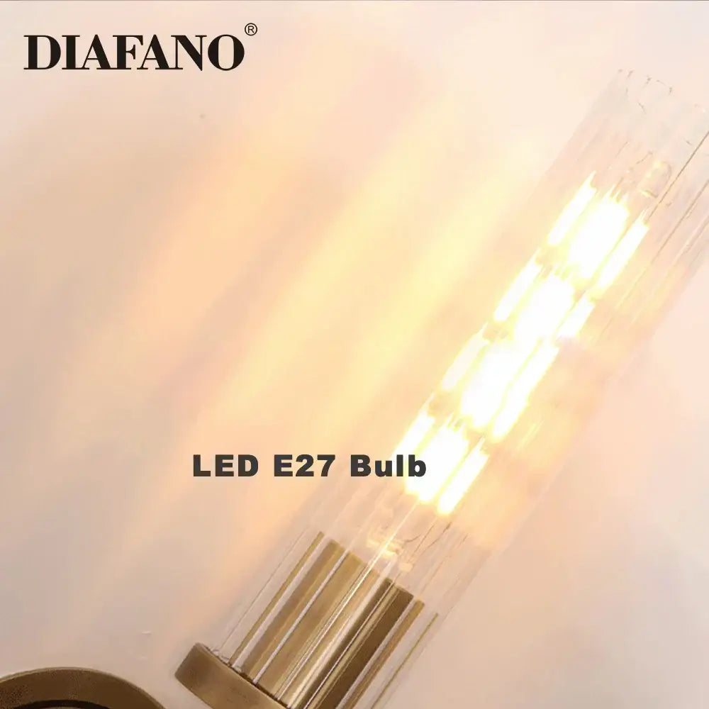 Clear glass led e27 bulb with warm glowing filament and brass base in elegant brass and black glass tube wall sconce decorbites copper wall sconce