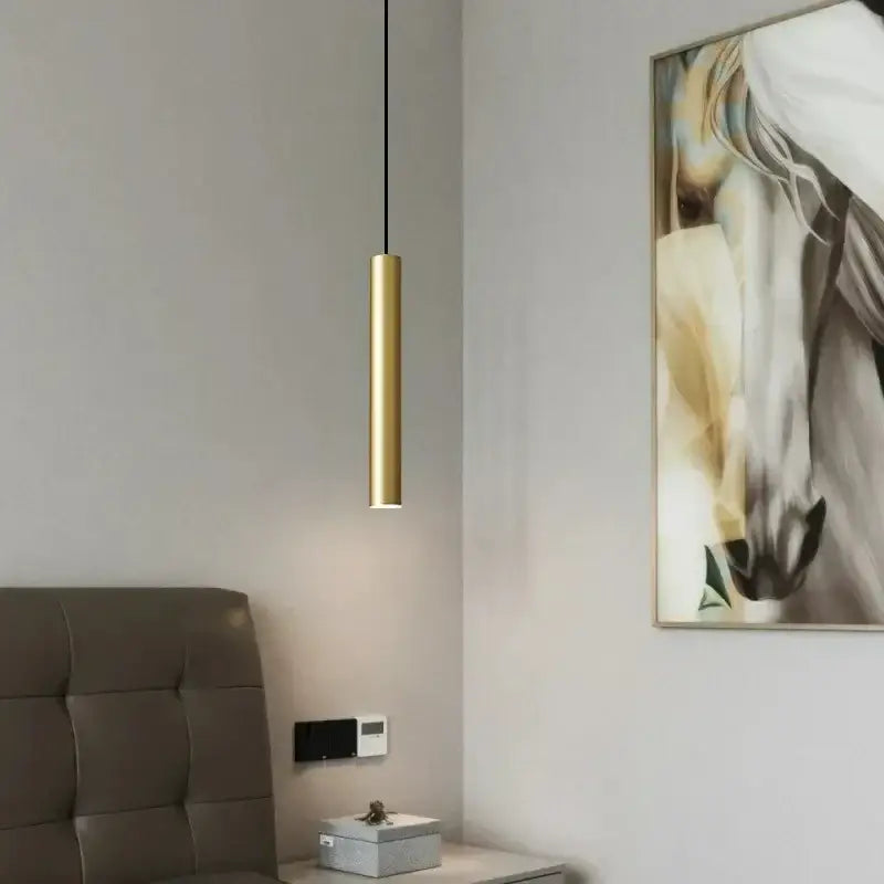 A sleek cylindrical elegant brass pendant light in gold with minimalist design for dining room decor by decorbites