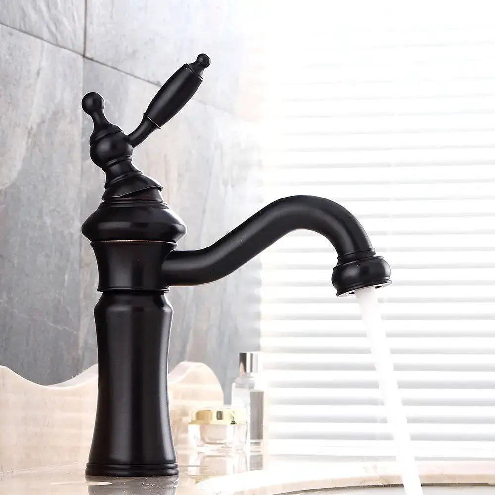 Black matte vintage-style basin faucet with ornate handle and curved spout for elegant brushed nickel bathroom decorbites