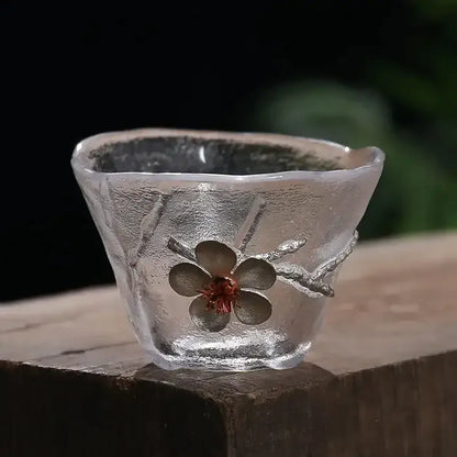 Elegant carved tin glass tea cup set featuring a translucent frosted cup with silver cherry blossom design