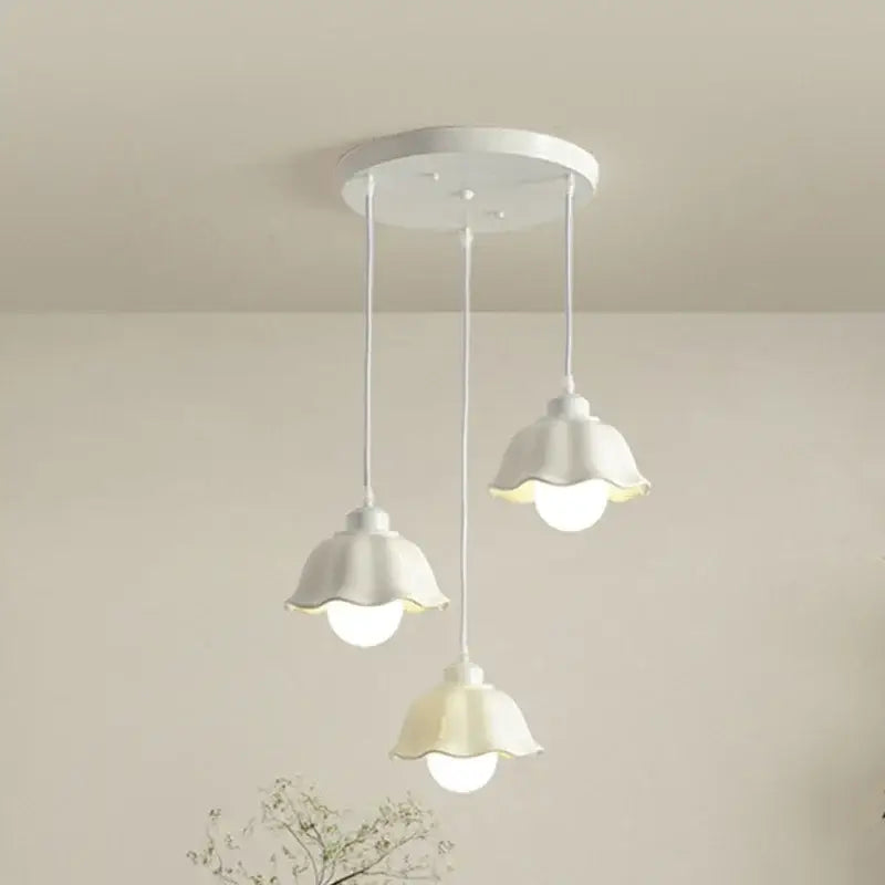 Elegant cream led chandelier with three bell-shaped white pendant shades and circular base for dining room decorbites elegant cream