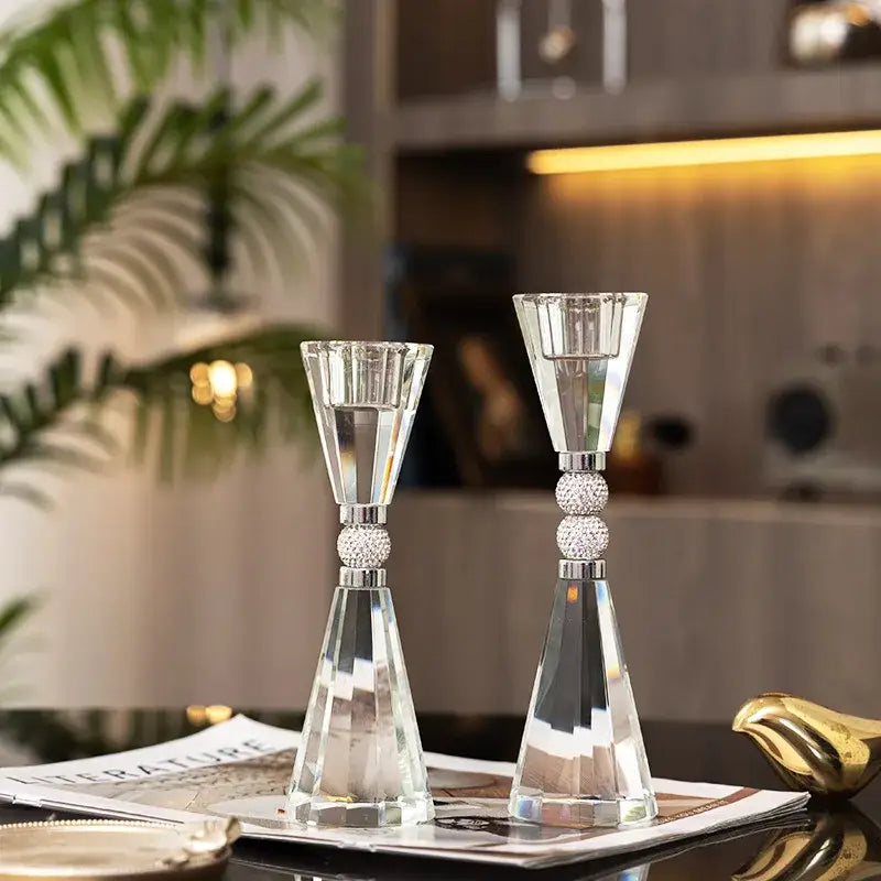 Elegant crystal candle holder set with faceted geometric designs and silver-toned spherical embellishments for dining decor