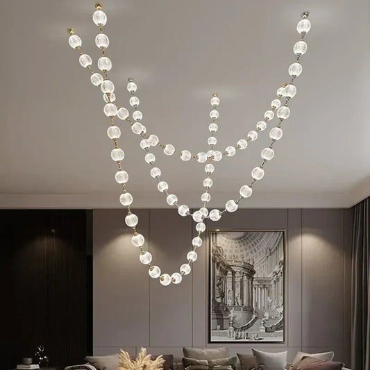 Elegant crystal and gold pendant lights featuring clear faceted beads on gold chains for staircase decorbites elegant pendant