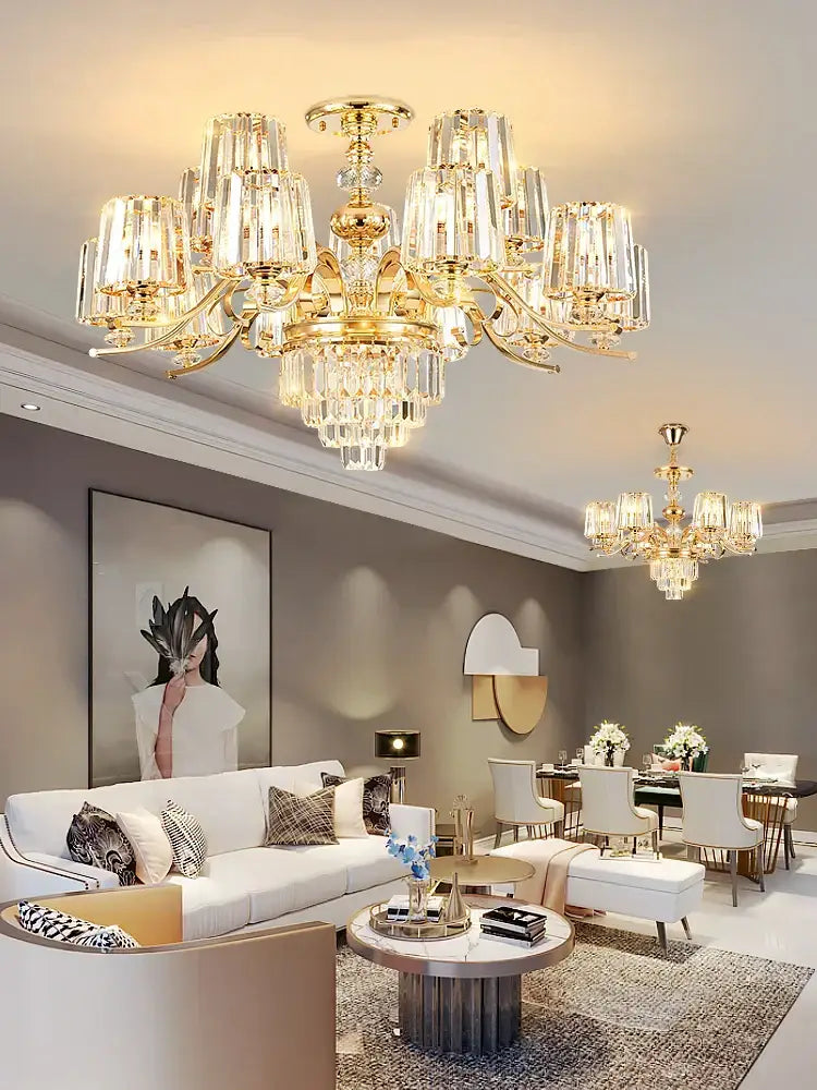 Gold-toned elegant crystal chandelier by decorbites featuring crystal prisms and dangling crystals for living room decor