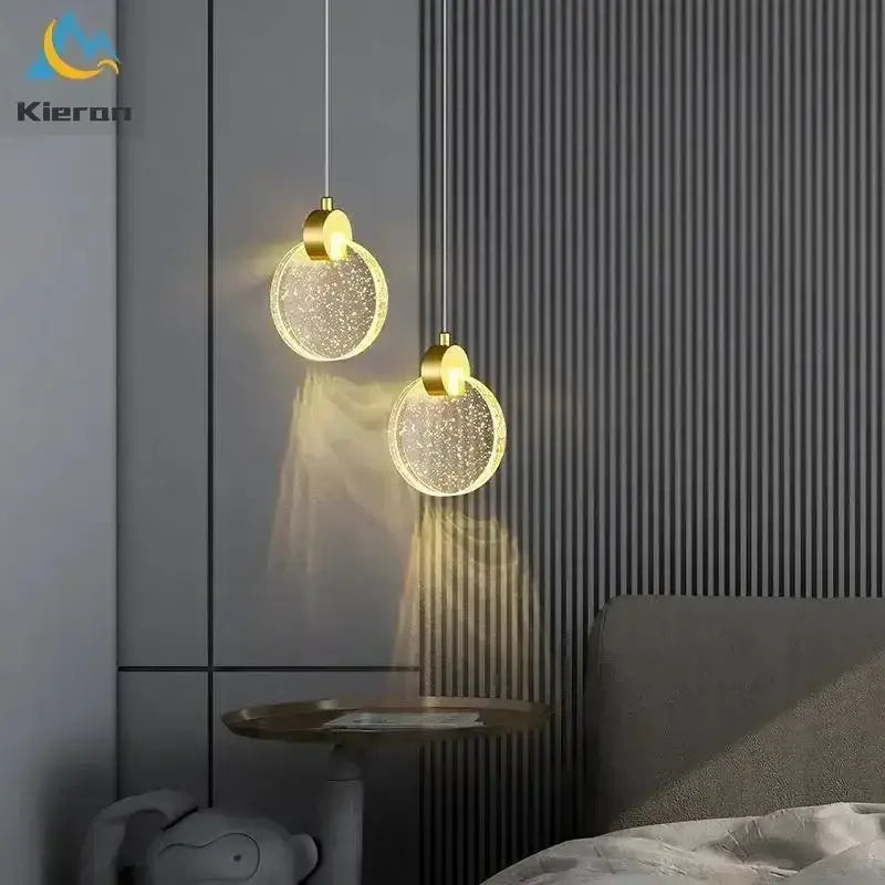 Two golden-toned decorbites elegant crystal led pendant lights with circular sparkling glass shades for dining room decor
