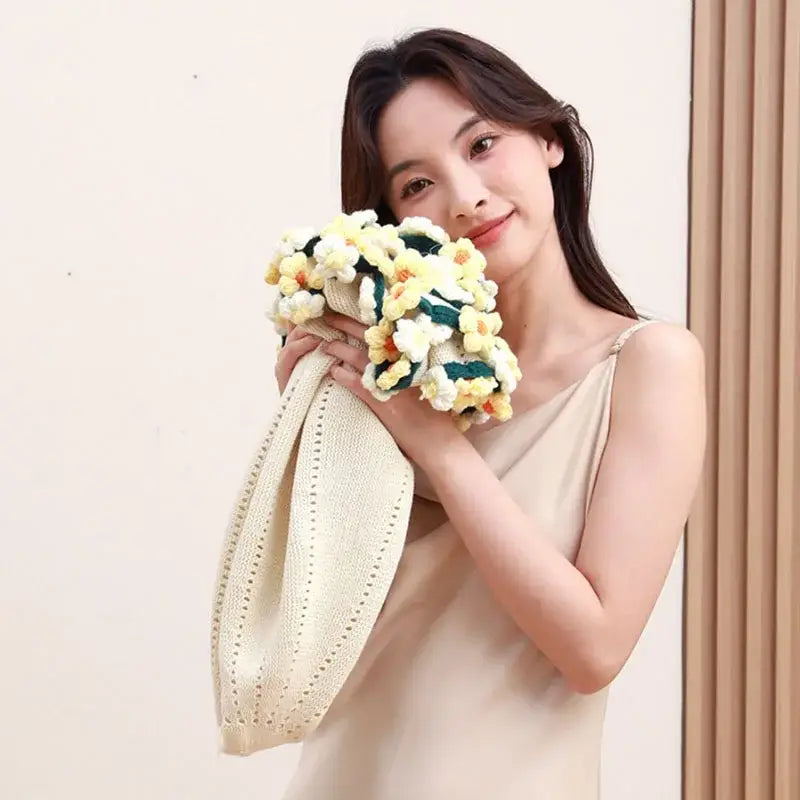 Cream-colored knitted tote bag with yellow and white crocheted flowers from decorbites elegant daisy bouquet soft collection
