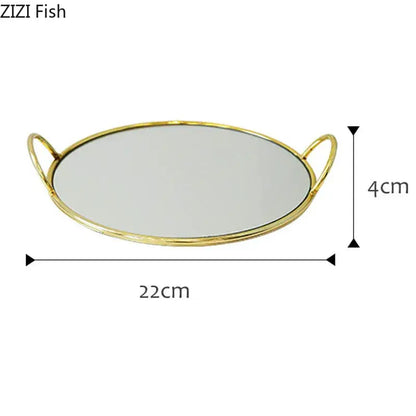 Gold-toned oval mirror tray with two loop decorbites brass handle storage handles measuring 22cm by 4cm