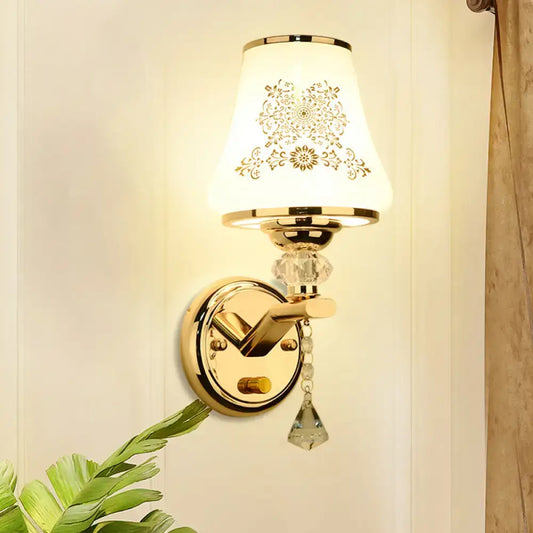 Elegant gold and white crystal wall light with gold floral patterned lampshade and crystal accents for reading wall light