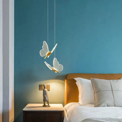 Delicate white butterfly pendant lamp with gold accents hanging from thin cords decorbites butterfly pendant lamp