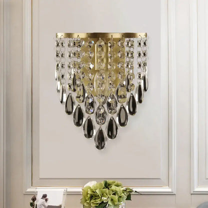 Elegant gold corridor wall mounted semi rounded sconce featuring beveled glass crystal with cascading teardrop accents