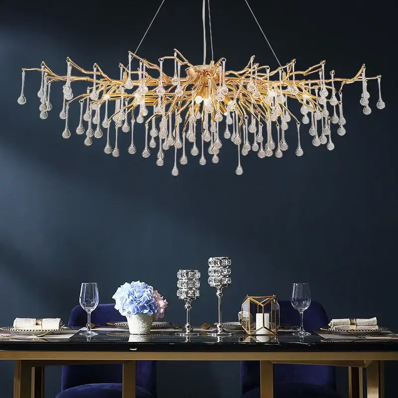 Elegant gold crystal chandelier with intricate branching arms and dangling teardrop pendants for living room decorbites elegant gold