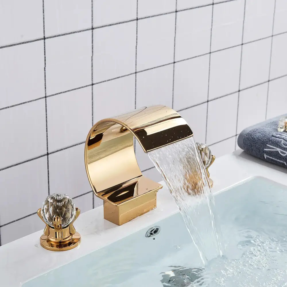 Elegant gold basin faucet set with crystal handles and sleek curved design for bathroom waterfall basin faucet