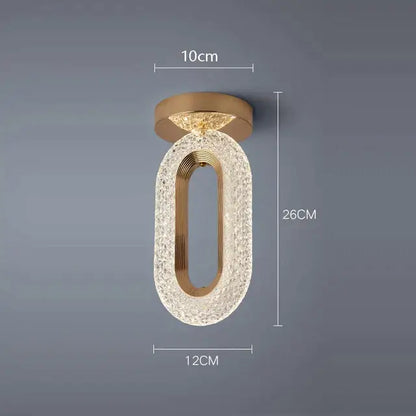 Elegant gold crystal oval pendant light chandelier with textured body and central metallic frame for living room