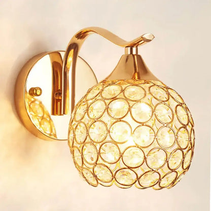 Elegant gold crystal wall sconce featuring a spherical globe design perfect for bedroom decorbites crystal wall lighting