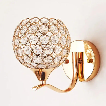 Elegant gold-toned crystal wall sconce featuring a spherical globe design ideal for bedroom decorbites crystal wall lighting