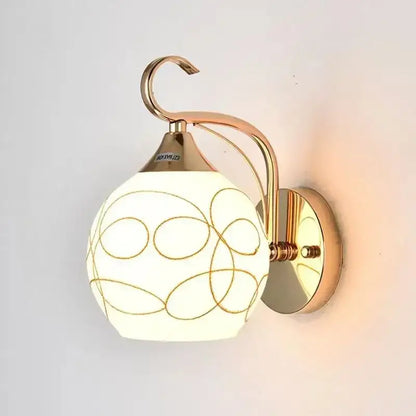 Elegant gold crystal wall sconce with a spherical frosted glass shade and brass-finished arm for bedroom decorbites crystal wall lighting