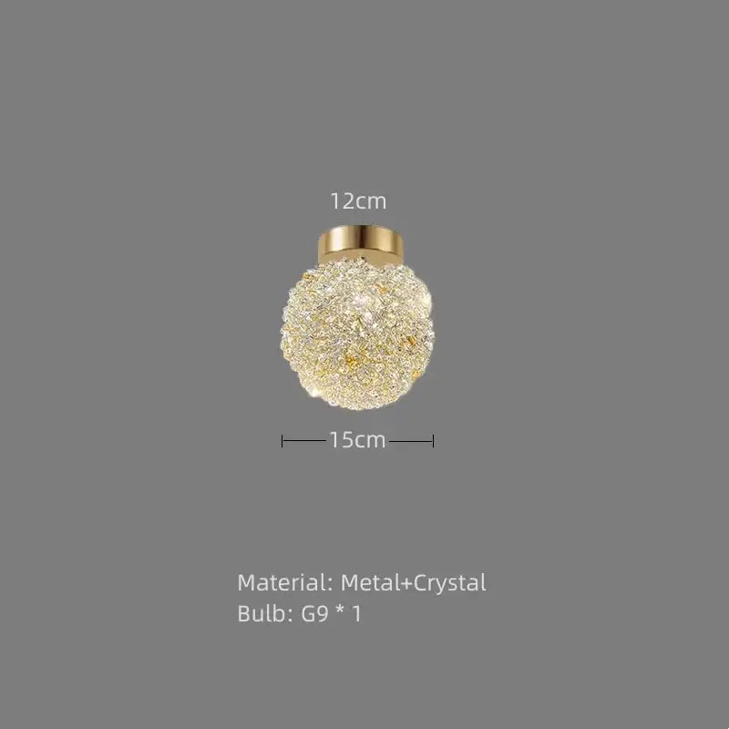 Elegant gold metal crystal pendant light featuring a spherical design with clear crystals for dining room decorbites