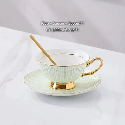 A delicate mint green decorbites gold porcelain tea cup with gold trim and textured pattern on matching saucer