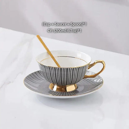 Elegant black and white striped porcelain teacup with gold trim, matching saucer, and golden spoon in decorbites gold porcelain tea set