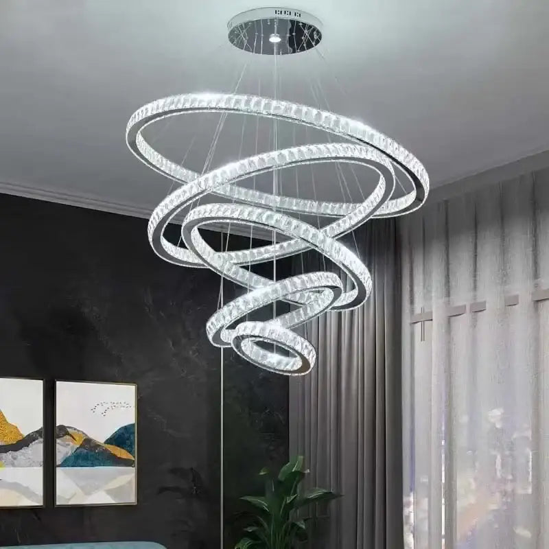 A modern decorbites elegant gold rings chandelier with multiple glowing crystal spiral rings for dining room decor