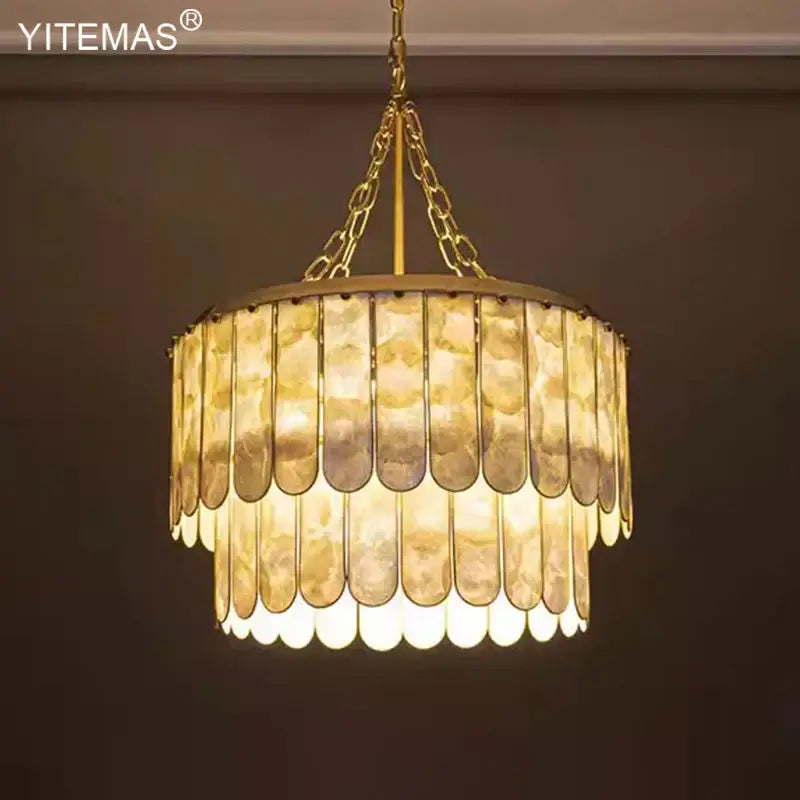 Elegant decorbites gold shell chandelier with layered translucent shell panels in a tiered living room pendant light design
